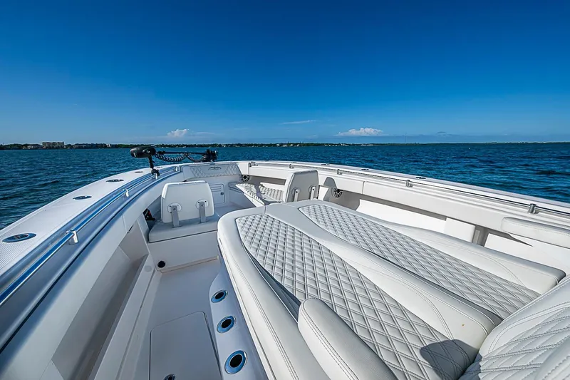 Slide: The Image of 2022 Invincible 39 Open Fisherman boat on calm blue waters, featuring luxurious seating. - 42
