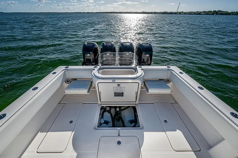 Slide: The Image of 2022 Invincible 39 Open Fisherman boat on open water, showcasing powerful engines. - 57