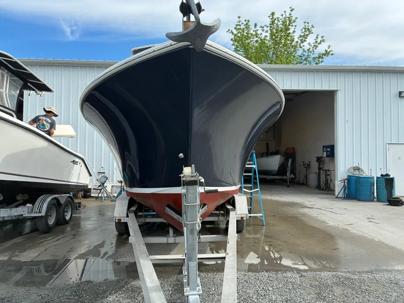 Slide: The Image of 2007 Sailfish 2660 boat on trailer outside workshop. - 2