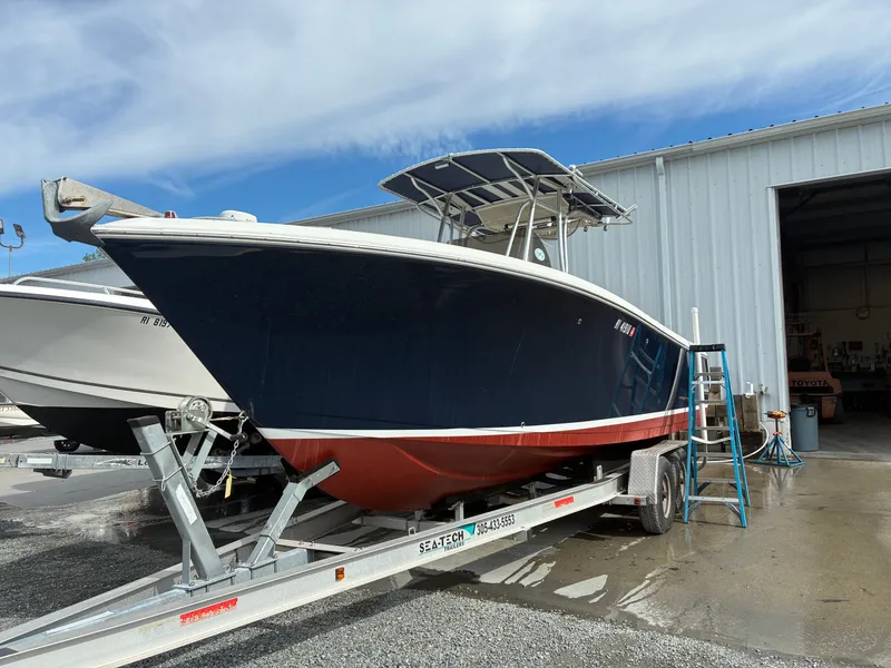 Slide: The Image of 2007 Sailfish 2660 boat on trailer outside warehouse. - 3