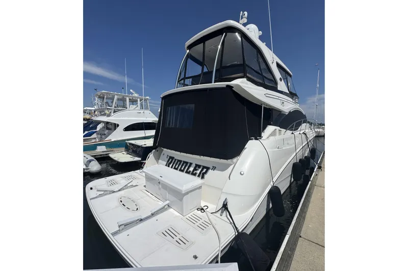 The Image of 2016 Sea Ray L590 Fly yacht docked at marina, rear view. - 1