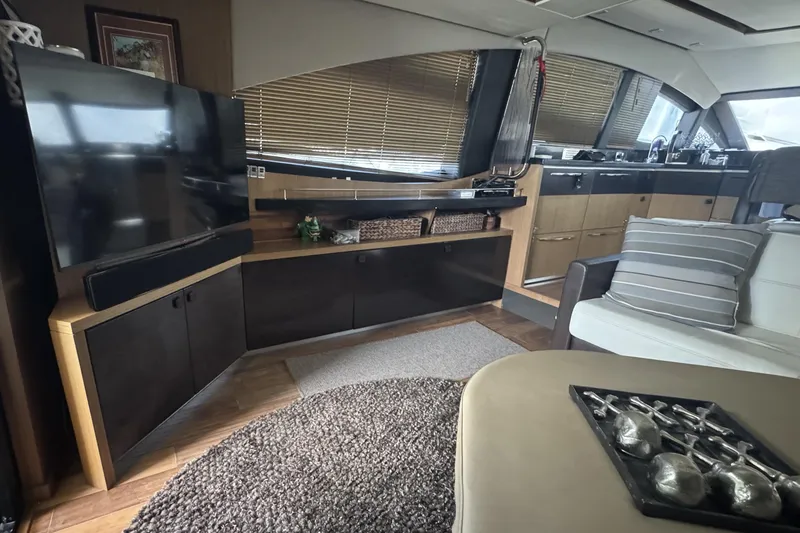 Slide: The Image of Luxurious interior of 2016 Sea Ray L590 Fly yacht with modern furnishings and entertainment system. - 14