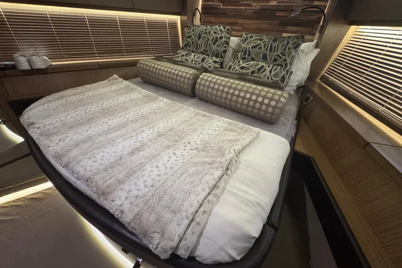 Slide: The Image of Luxurious bedroom interior of 2016 Sea Ray L590 Fly yacht with plush bedding and elegant decor. - 17