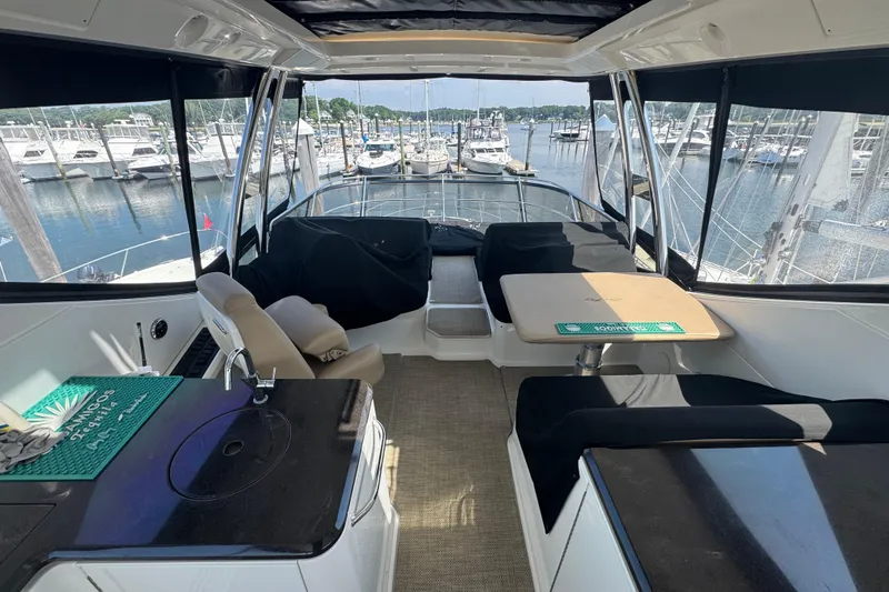 Slide: The Image of Interior view of 2016 Sea Ray L590 Fly yacht with marina backdrop. - 2
