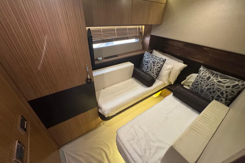 Slide: The Image of Luxurious cabin interior of 2016 Sea Ray L590 Fly yacht with twin beds and modern decor. - 20