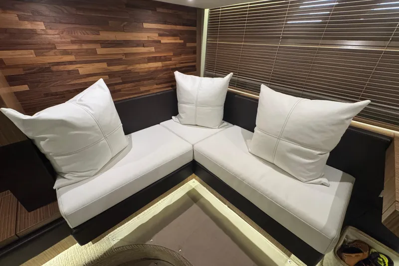 Slide: The Image of Luxurious interior seating with white cushions on 2016 Sea Ray L590 Fly yacht. - 22