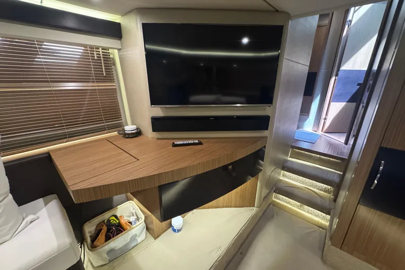 Slide: The Image of Luxurious interior of 2016 Sea Ray L590 Fly yacht with modern TV and wooden accents. - 23