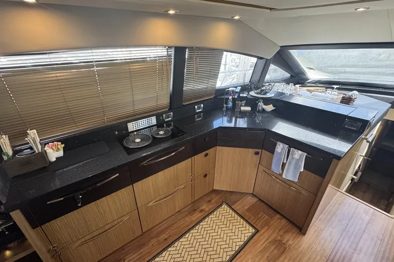 Slide: The Image of Luxurious kitchen interior of 2016 Sea Ray L590 Fly yacht with modern amenities. - 25
