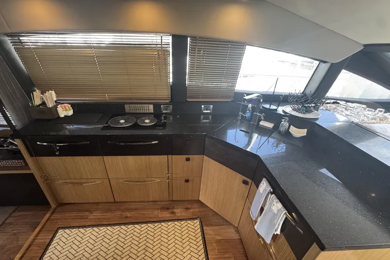 Slide: The Image of Luxurious kitchen interior of 2016 Sea Ray L590 Fly yacht with sleek countertops and modern appliances. - 26