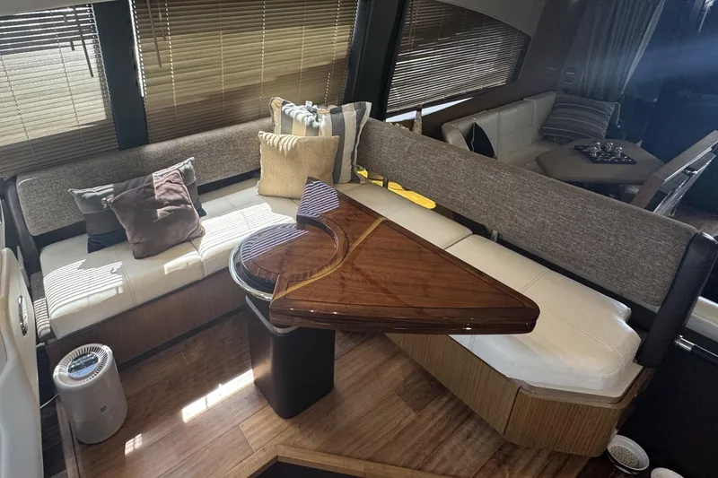 Slide: The Image of Luxurious interior of 2016 Sea Ray L590 Fly yacht with elegant seating and wooden table. - 28