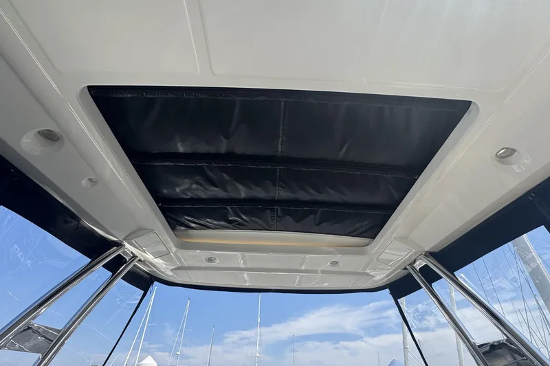 Slide: The Image of 2016 Sea Ray L590 Fly yacht interior ceiling with sunroof and sleek design. - 3