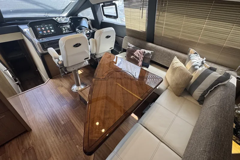 Slide: The Image of Luxurious interior of 2016 Sea Ray L590 Fly yacht with elegant seating and polished wood table. - 30