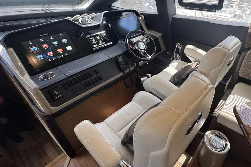 Slide: The Image of Luxurious 2016 Sea Ray L590 Fly yacht cockpit with advanced navigation systems and plush seating. - 31