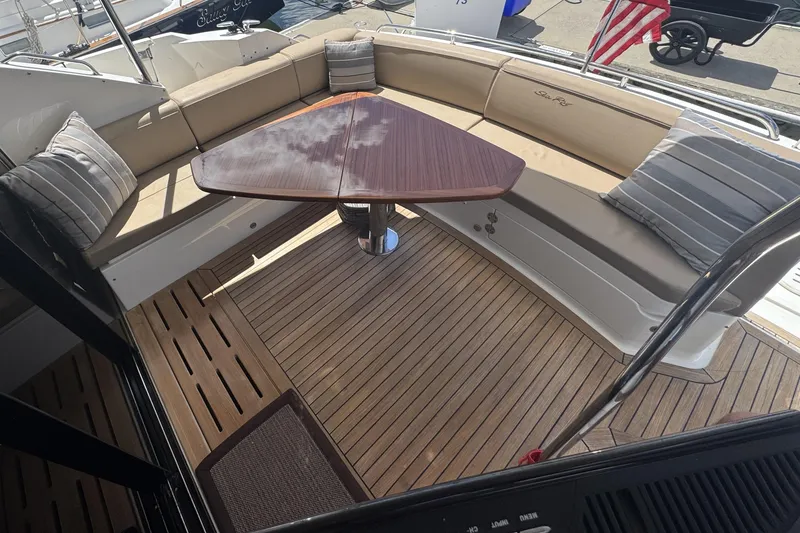 Slide: The Image of Luxurious interior seating with white cushions on 2016 Sea Ray L590 Fly yacht. - 39