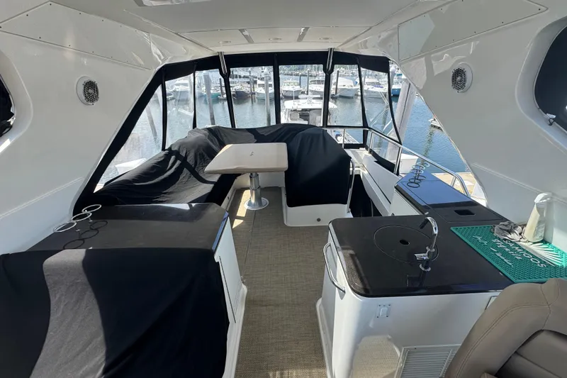 Slide: The Image of Interior of 2016 Sea Ray L590 Fly yacht with seating and kitchenette, docked at marina. - 4