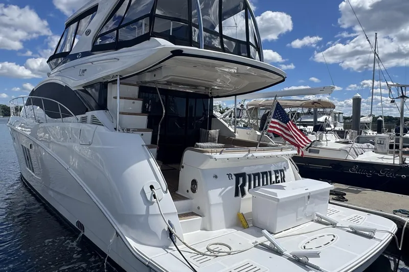 Slide: The Image of 2016 Sea Ray L590 Fly yacht docked at marina, rear view. - 47