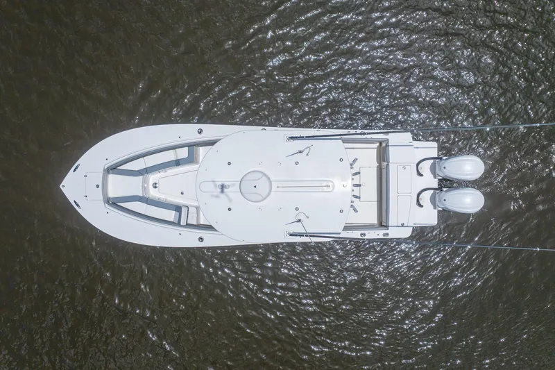 Slide: The Image of Aerial view of 2022 Regulator 28 boat on water, showcasing sleek design and twin engines. - 9