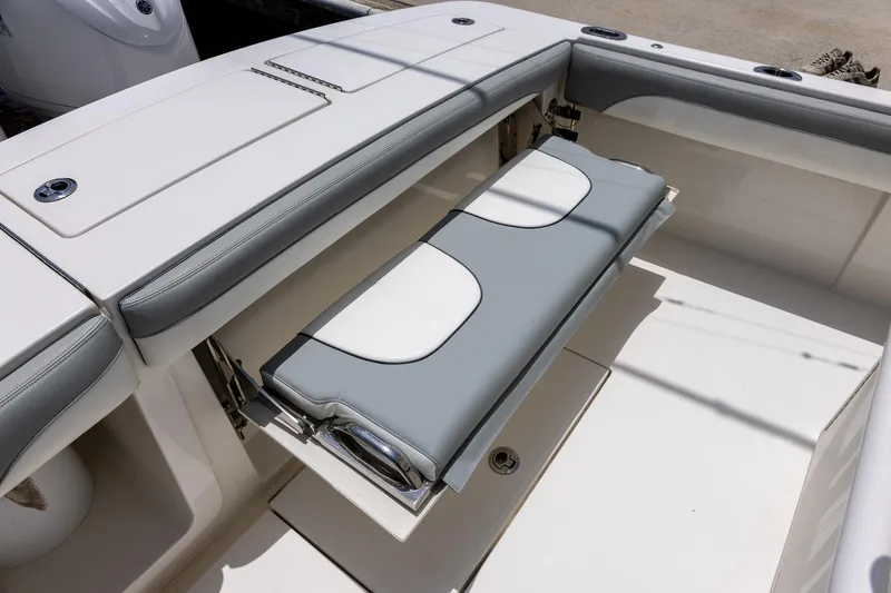 Slide: The Image of 2022 Regulator 28 boat with foldable seating in the cockpit area. - 21
