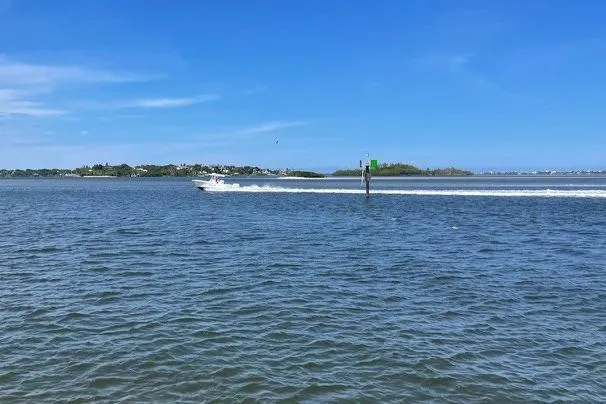Slide: The Image of 2022 Regulator 28 boat cruising on a sunny day in open water. - 2