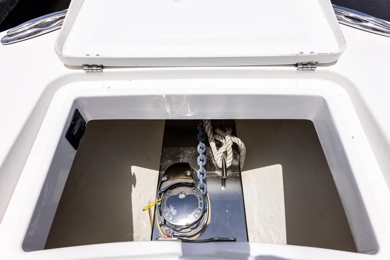 Slide: The Image of Anchor storage compartment on a 2022 Regulator 28 boat, featuring chain and rope. - 37