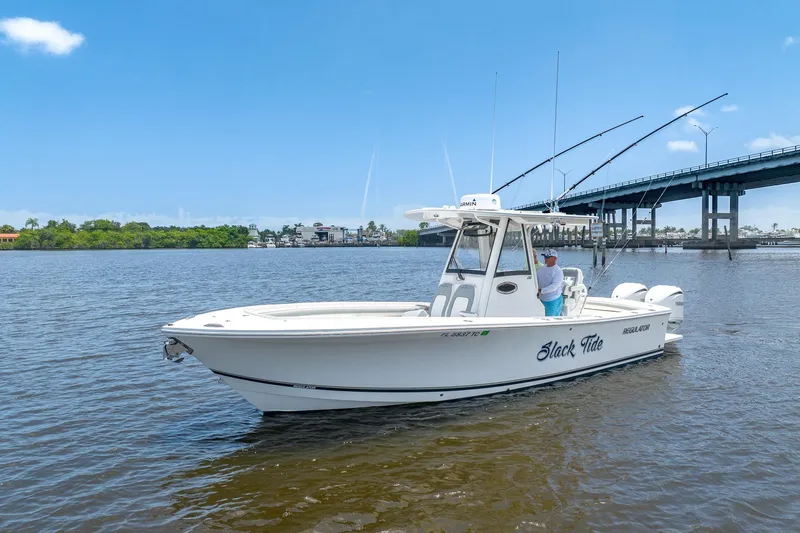 Slide: The Image of 2022 Regulator 28 boat on water near a bridge under clear blue sky. - 7