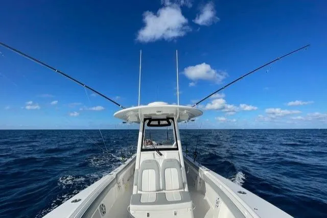 Slide: The Image of 2022 Regulator 28 boat on open ocean under clear blue sky. - 4