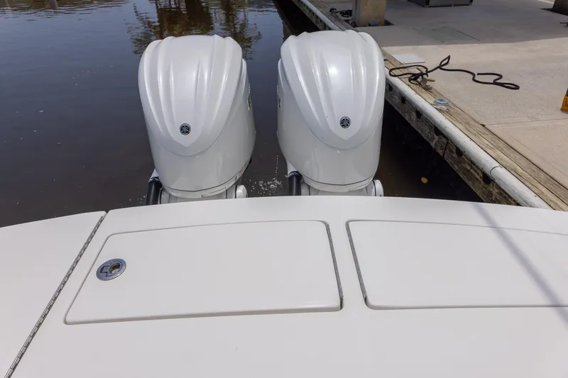 Slide: The Image of 2022 Regulator 28 boat with dual outboard engines docked at marina. - 44