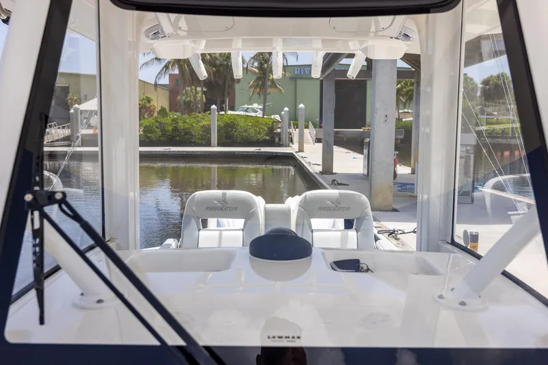 Slide: The Image of 2022 Regulator 28 boat interior view at marina dock. - 38