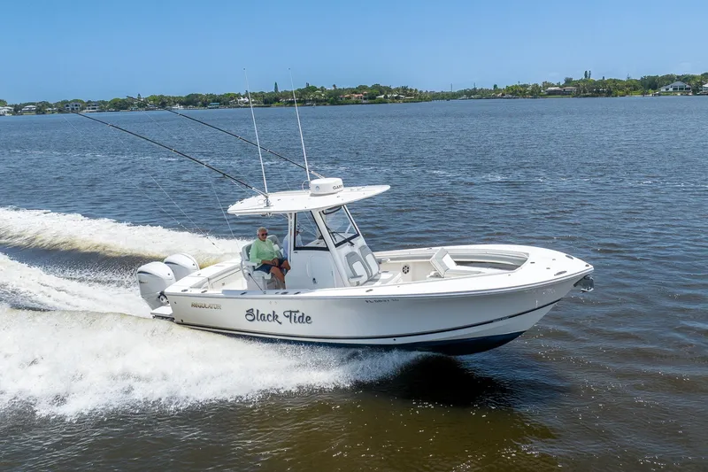 The Image of 2022 Regulator 28 boat cruising on a sunny day with fishing rods. - 0