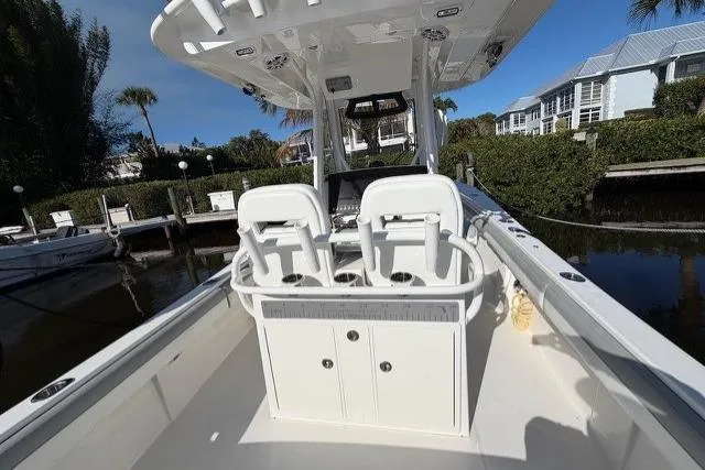 Slide: The Image of 2022 Regulator 28 boat with dual seats, docked in a scenic marina setting. - 7