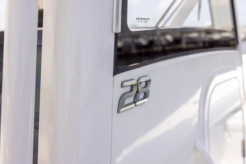 Slide: The Image of 2022 Regulator 28 boat, close-up of model number on sleek white exterior. - 27
