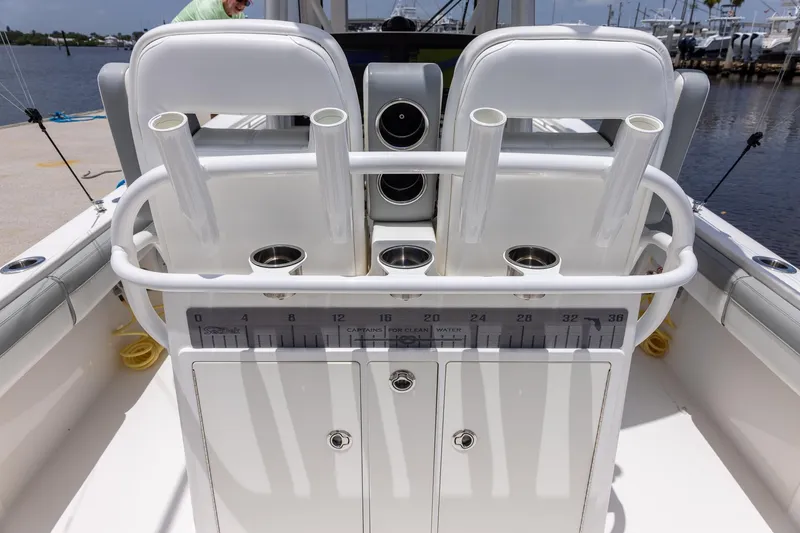 Slide: The Image of 2022 Regulator 28 boat cockpit with rod holders and storage compartments. - 19