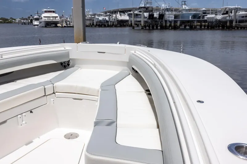 Slide: The Image of 2022 Regulator 28 boat interior with white seating, docked at marina. - 30