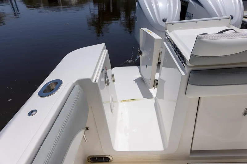 Slide: The Image of 2022 Regulator 28 boat interior with seating and water access door. - 48