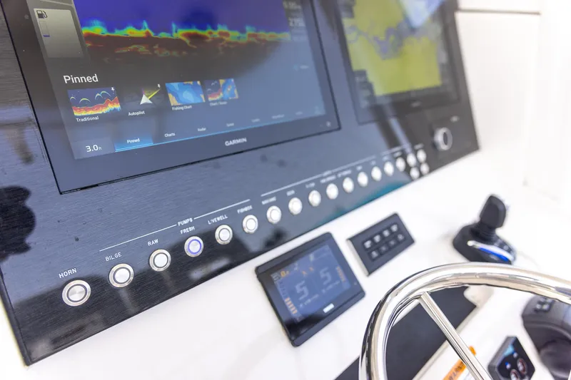 Slide: The Image of 2022 Regulator 28 boat dashboard with Garmin navigation system and control panel. - 52