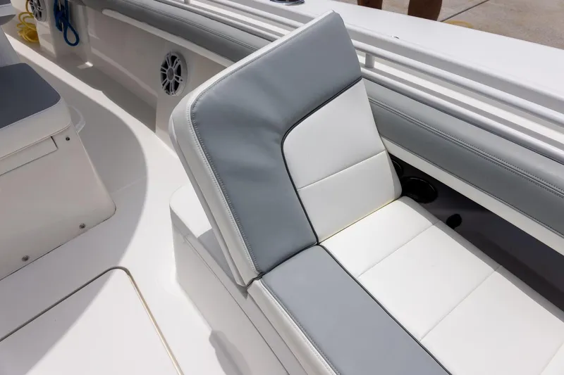 Slide: The Image of 2022 Regulator 28 boat interior with gray and white cushioned seating. - 41