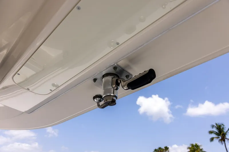 Slide: The Image of 2022 Regulator 28 boat detail with handle, under clear blue sky. - 43