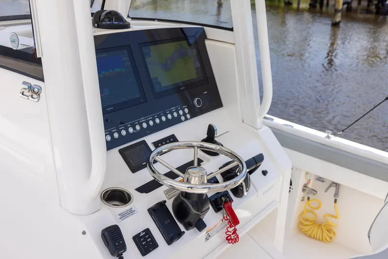 Slide: The Image of 2022 Regulator 28 boat helm with advanced navigation displays and controls. - 15
