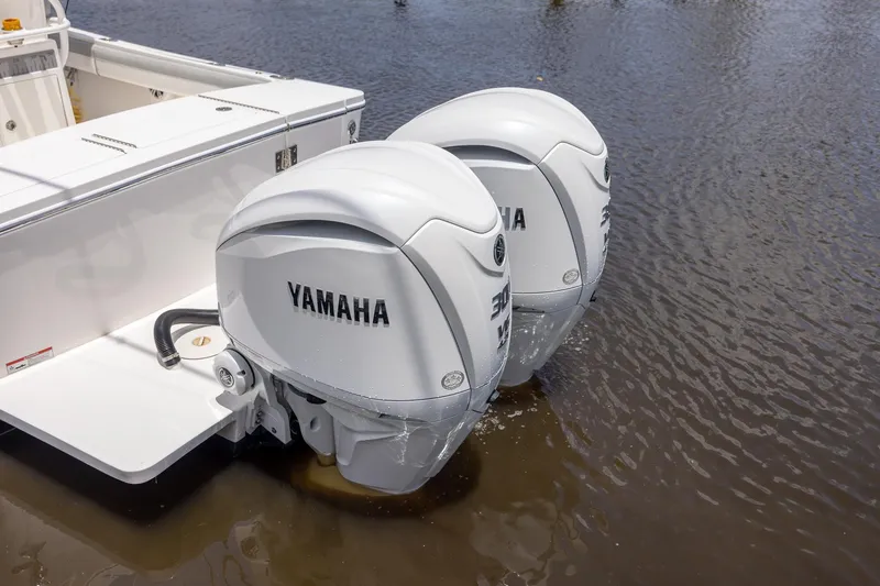 Slide: The Image of 2022 Regulator 28 boat with twin Yamaha outboard engines in water. - 14