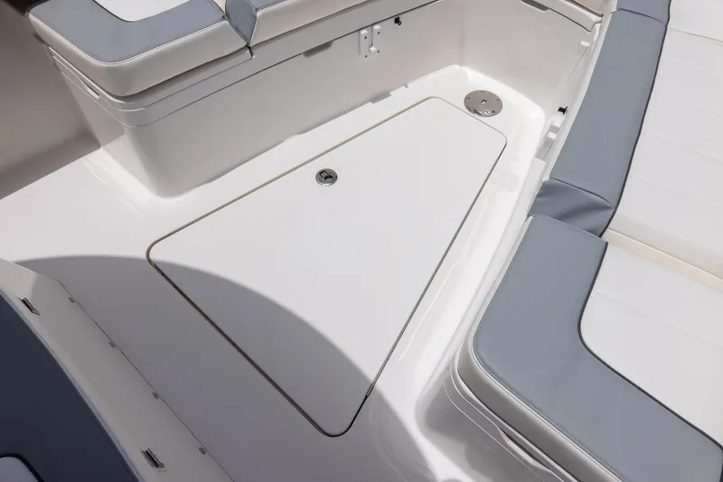 Slide: The Image of 2022 Regulator 28 boat interior with cushioned seating and storage compartment. - 39