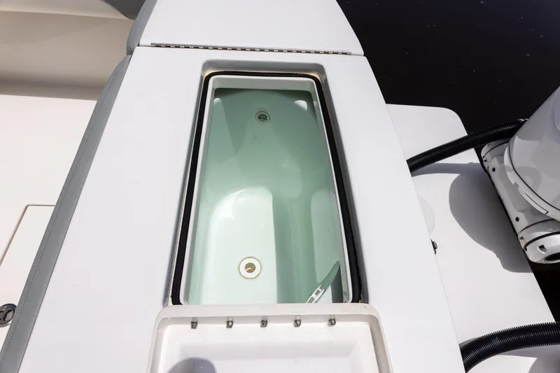 Slide: The Image of Livewell on 2022 Regulator 28 boat, open lid, white interior. - 45