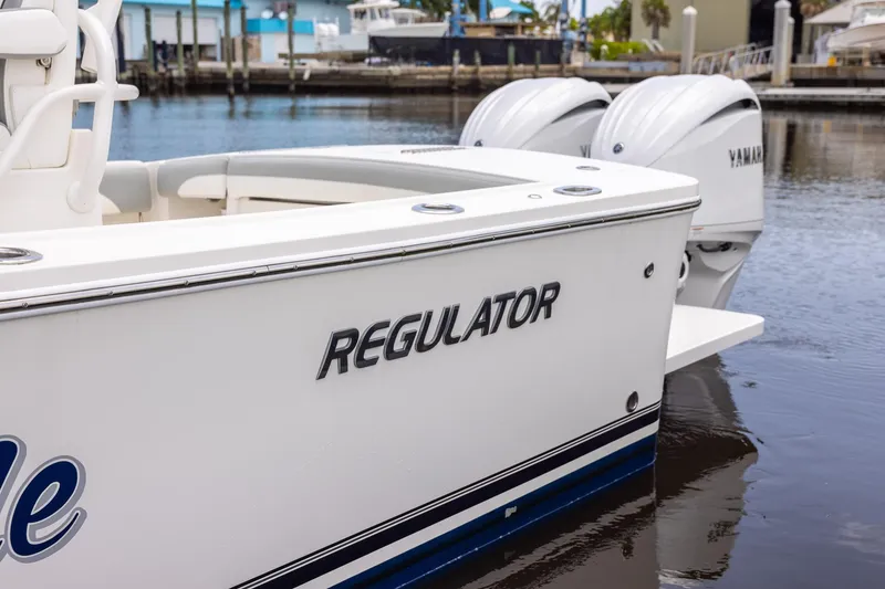 Slide: The Image of 2022 Regulator 28 boat with Yamaha engines docked at marina. - 54