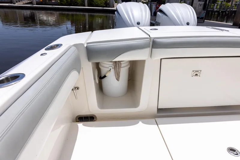 Slide: The Image of 2022 Regulator 28 boat interior with storage compartment and seating. - 23