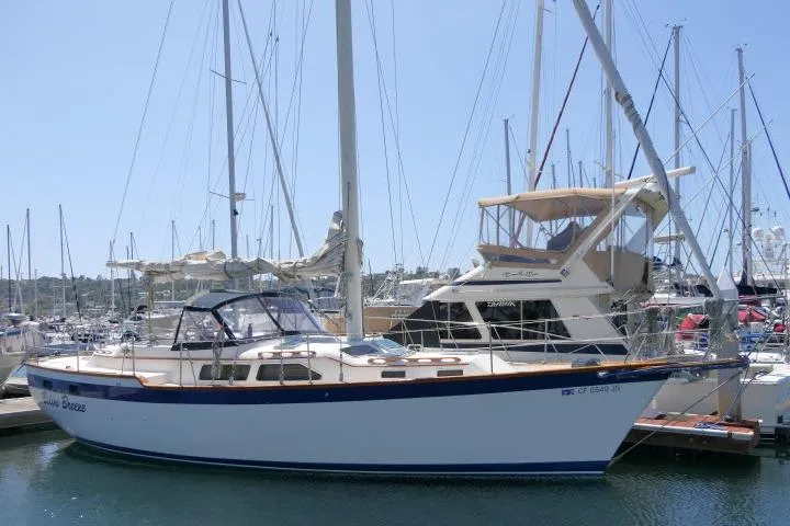 The Image of 1988 Irwin 38-2 sailboat docked in a marina, surrounded by other boats. - 1