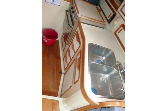 Slide: The Image of 1988 Irwin 38-2 yacht kitchen with dual sinks and wooden cabinetry. - 11