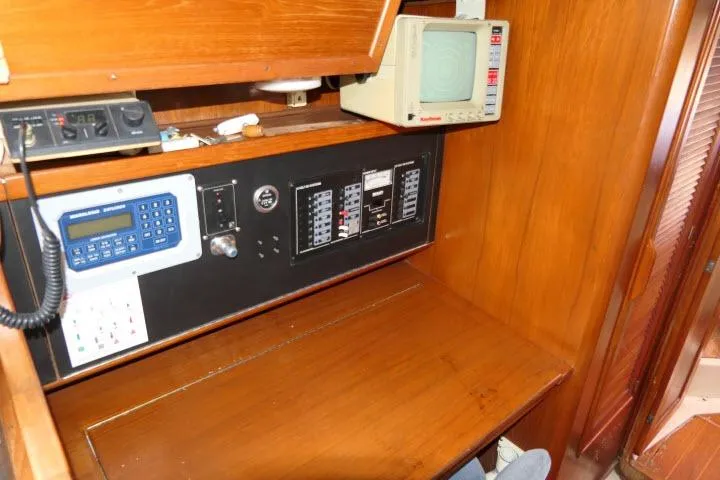 Slide: The Image of Navigation station of 1988 Irwin 38-2 sailboat with control panels and electronics. - 15