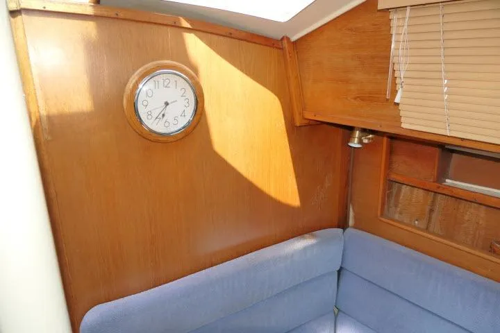 Slide: The Image of Interior of 1988 Irwin 38-2 sailboat with clock and blue seating. - 18