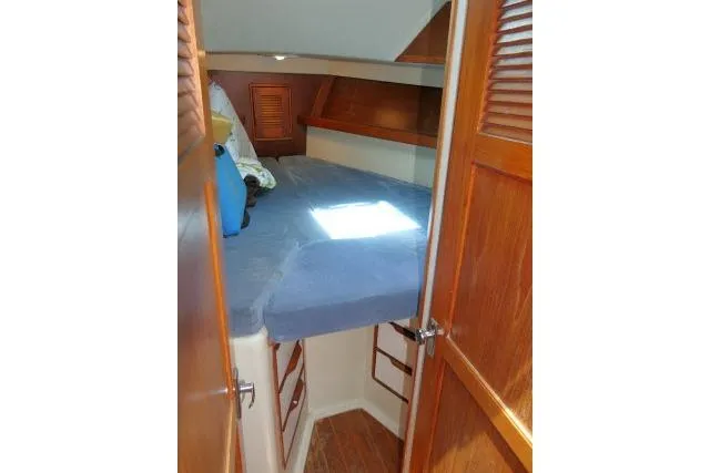 Slide: The Image of Cozy cabin interior of 1988 Irwin 38-2 sailboat with wooden accents and blue bedding. - 19