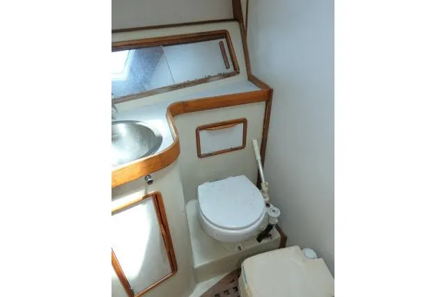 Slide: The Image of 1988 Irwin 38-2 yacht bathroom with sink, toilet, and wooden trim. - 20
