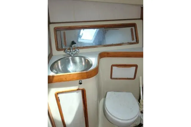 Slide: The Image of 1988 Irwin 38-2 yacht bathroom with sink, mirror, and toilet. - 21